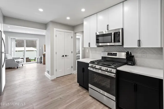 a view of a chair and table in backyard of the house