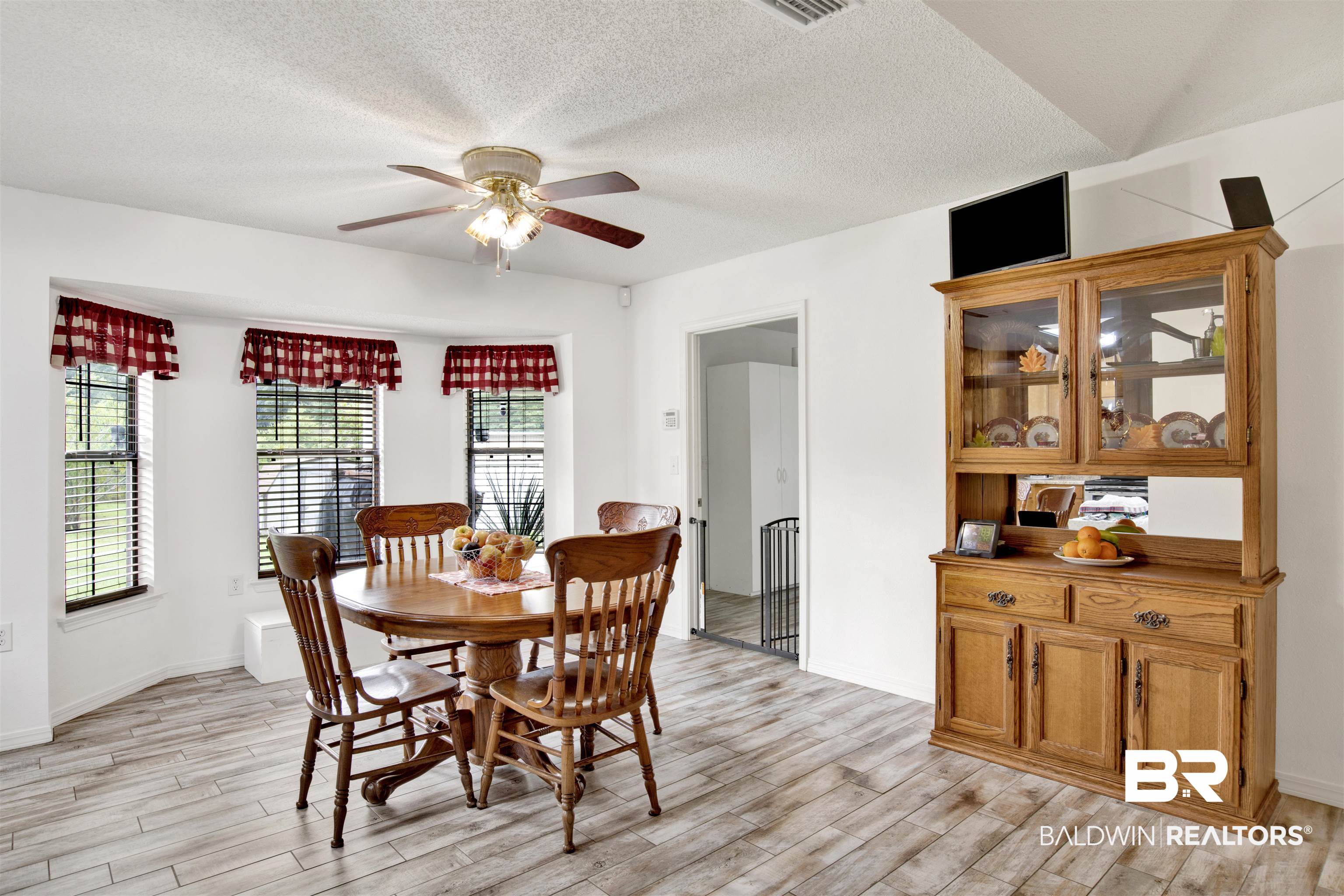 54563 Splinter Hill Road Perdido, AL 36562 - Photo 13 of 29 Dining room featuring a textured ceiling, ceiling fan, and light hardwood / wood-style floors