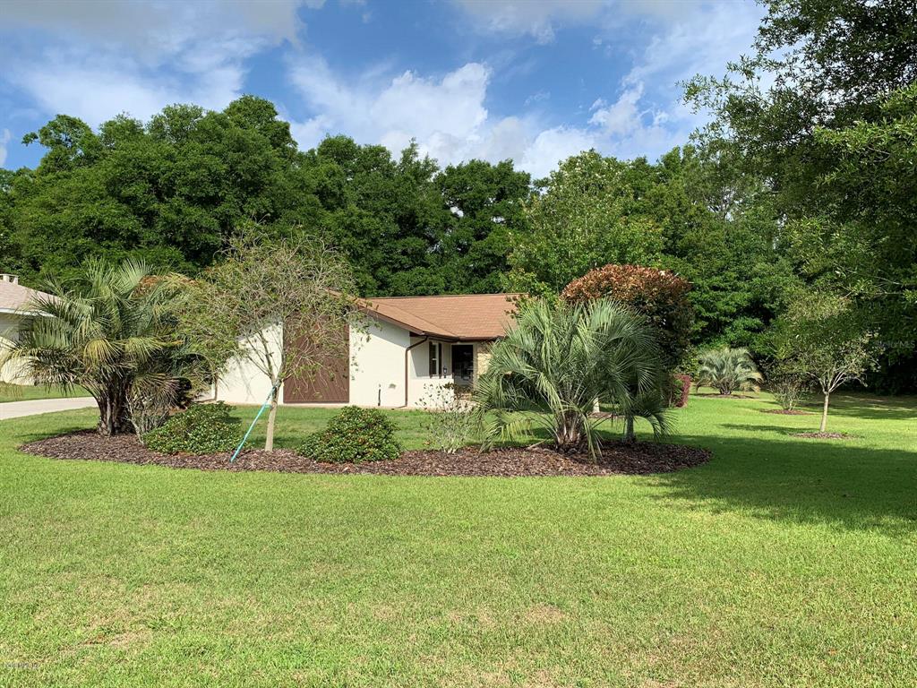 a view of a house with a backyard