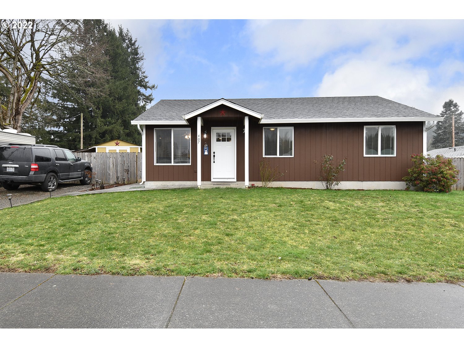 407 West Yacolt Road Yacolt, WA 98675 - Photo 1 of 21 a front view of a house with a yard and garage