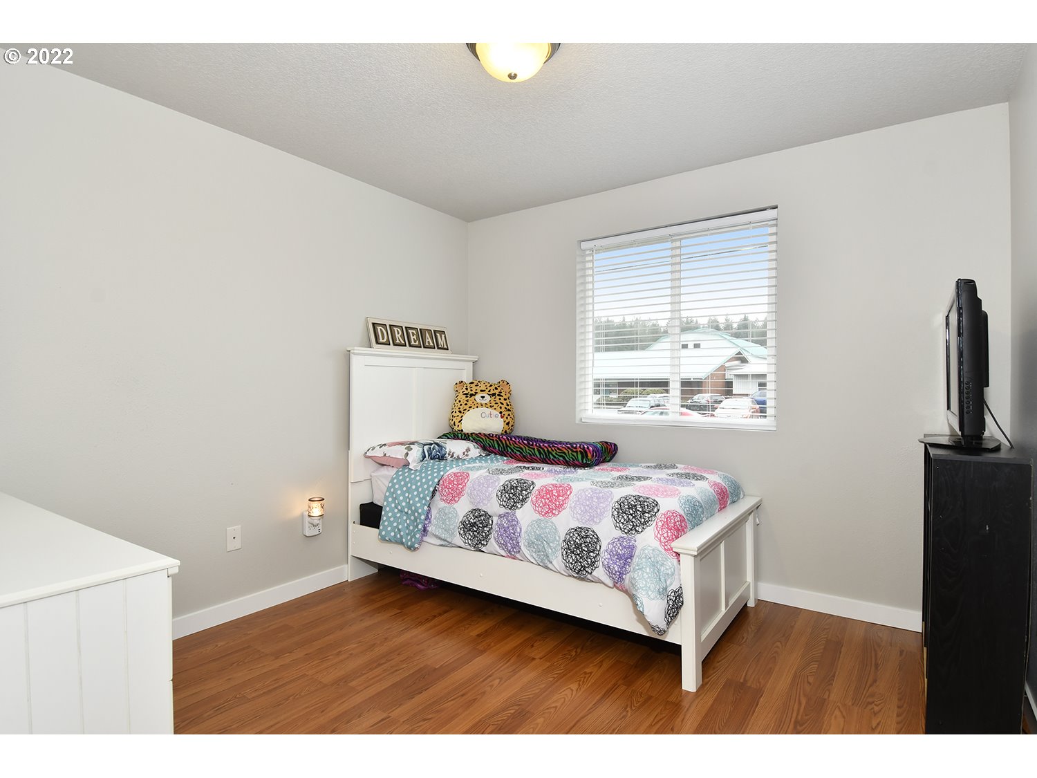 407 West Yacolt Road Yacolt, WA 98675 - Photo 13 of 21 a bedroom with a bed and wooden floor