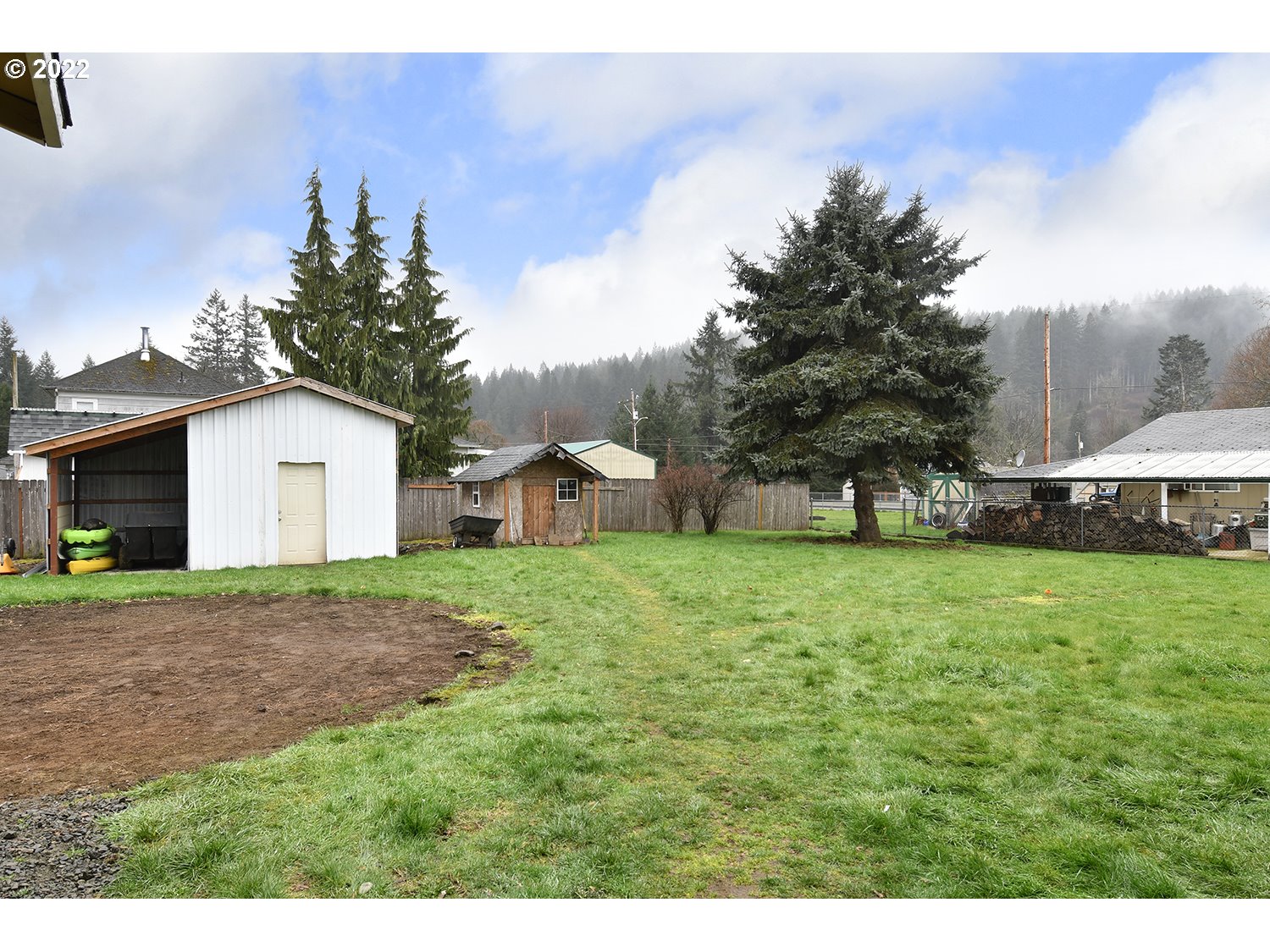 407 West Yacolt Road Yacolt, WA 98675 - Photo 17 of 21 a view of a house with yard and a garden