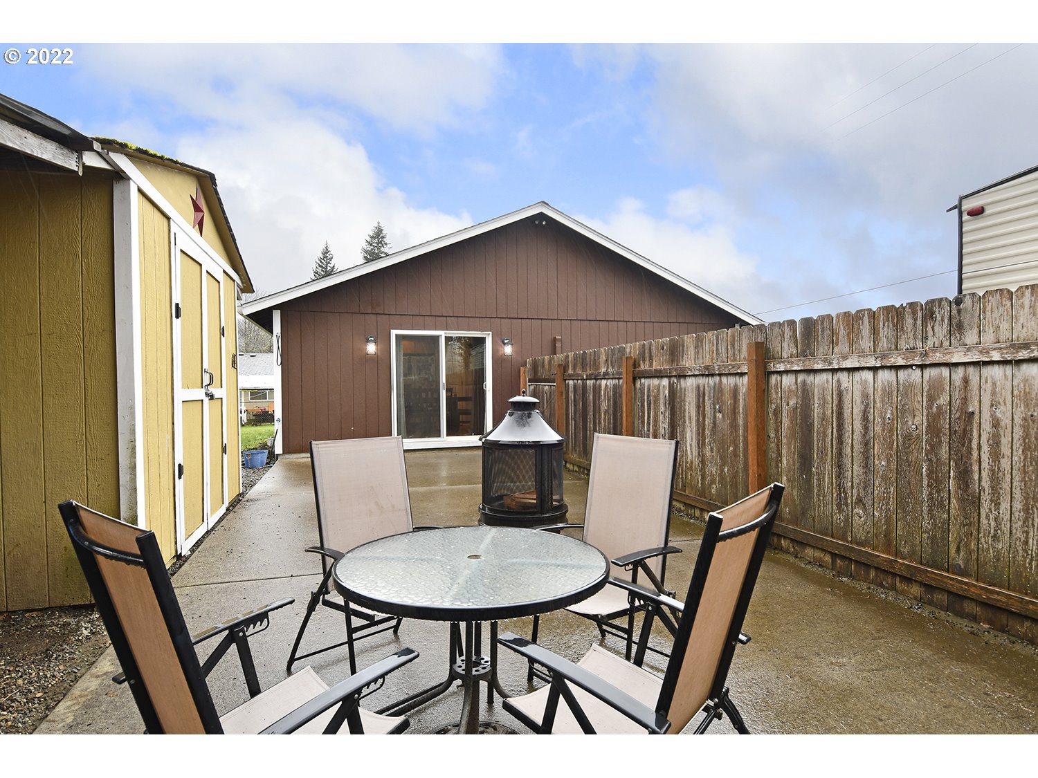 407 West Yacolt Road Yacolt, WA 98675 - Photo 20 of 21 a view of a patio with table and chairs with wooden floor and fence