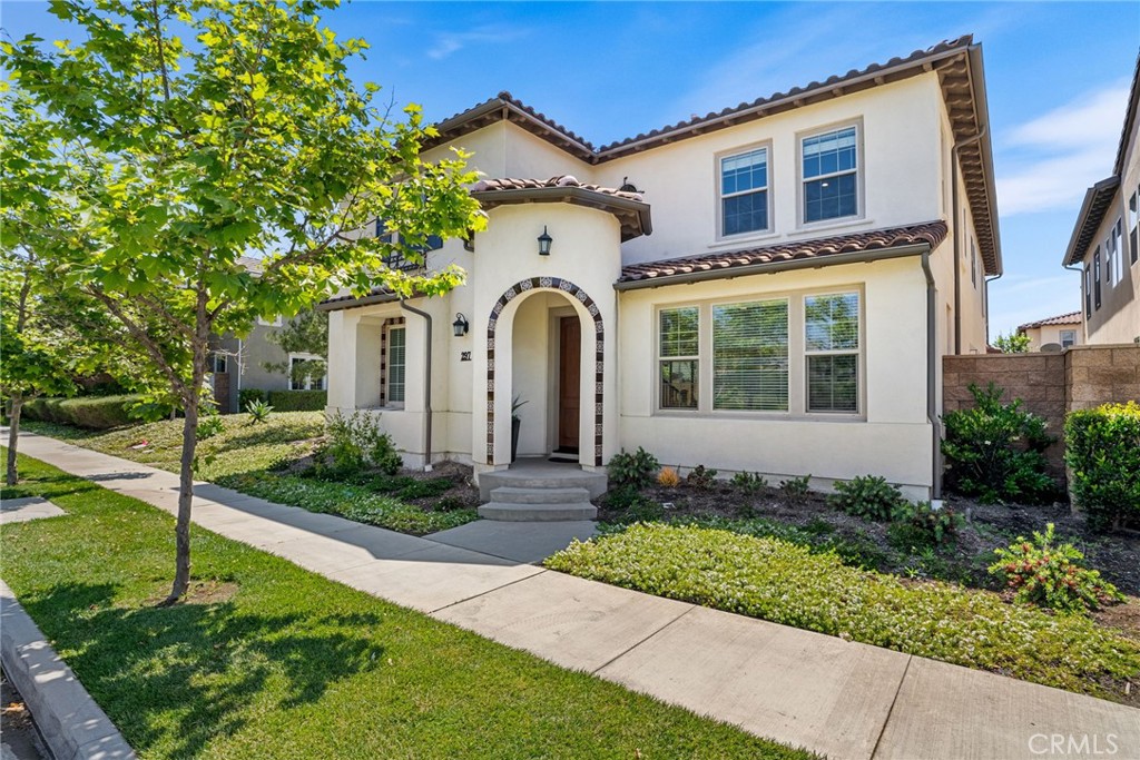 a front view of a house with a garden