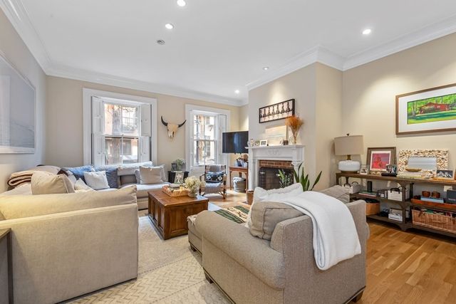 a living room with fireplace furniture and a window
