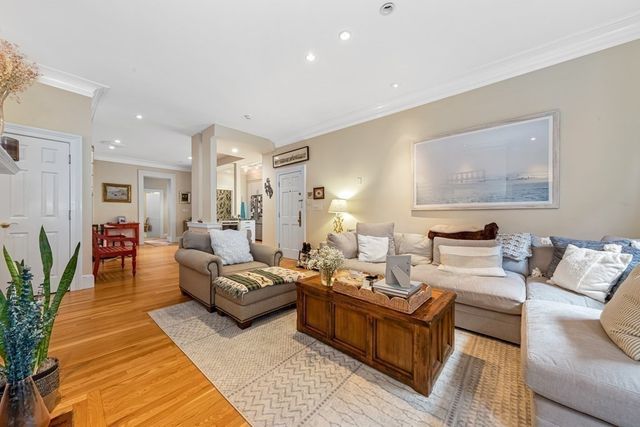 a living room with furniture wooden floor and a table