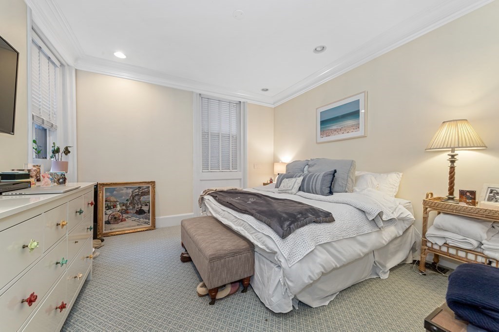 3 Myrtle Street, Unit 1 Boston, MA 02114 - Photo 16 of 25 a spacious bedroom with a bed and dresser