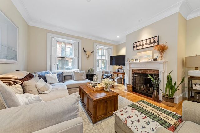 a living room with furniture and a fireplace