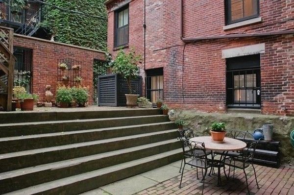 a view of a patio with two chairs and a table