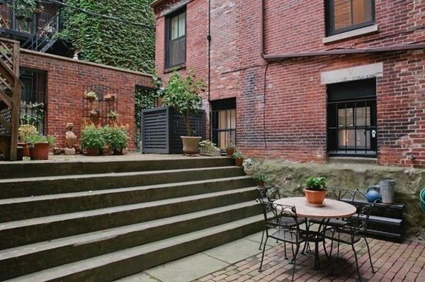 3 Myrtle Street, Unit 1 Boston, MA 02114 - Photo 23 of 25 a view of a patio with two chairs and a table