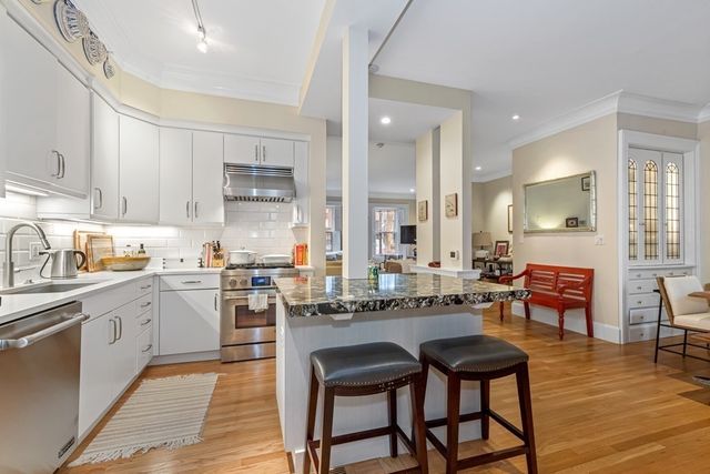 a large kitchen with a table and chairs