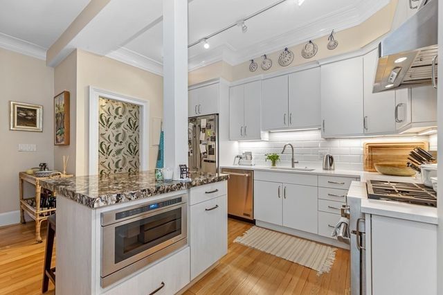 a kitchen with a stove oven and sink
