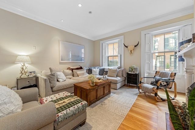a living room with furniture and a lamp