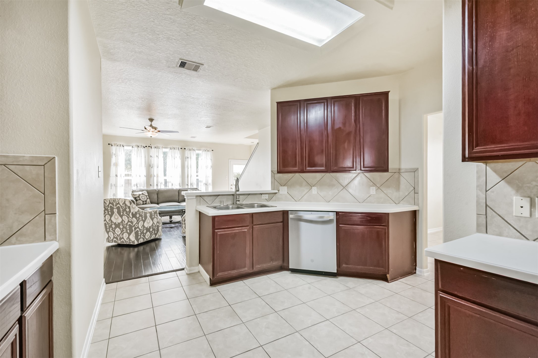 1810 Sun Point Court Humble, TX 77396 - Photo 10 of 38 a kitchen with granite countertop a sink cabinets and stainless steel appliances