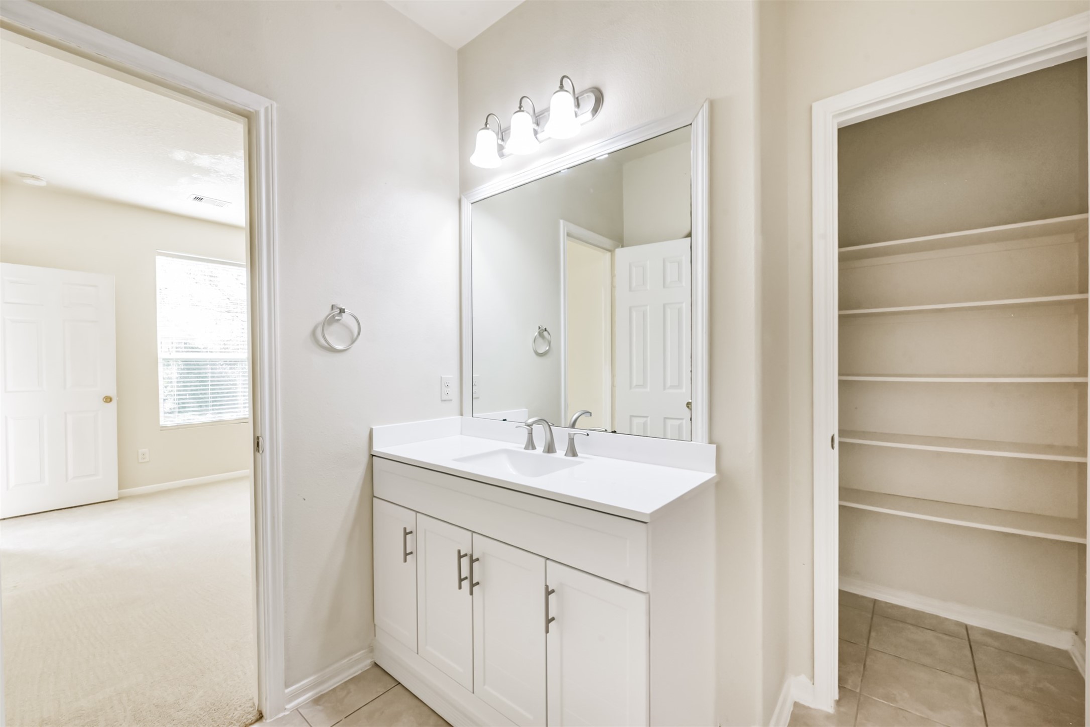 1810 Sun Point Court Humble, TX 77396 - Photo 20 of 38 a bathroom with a sink and a mirror