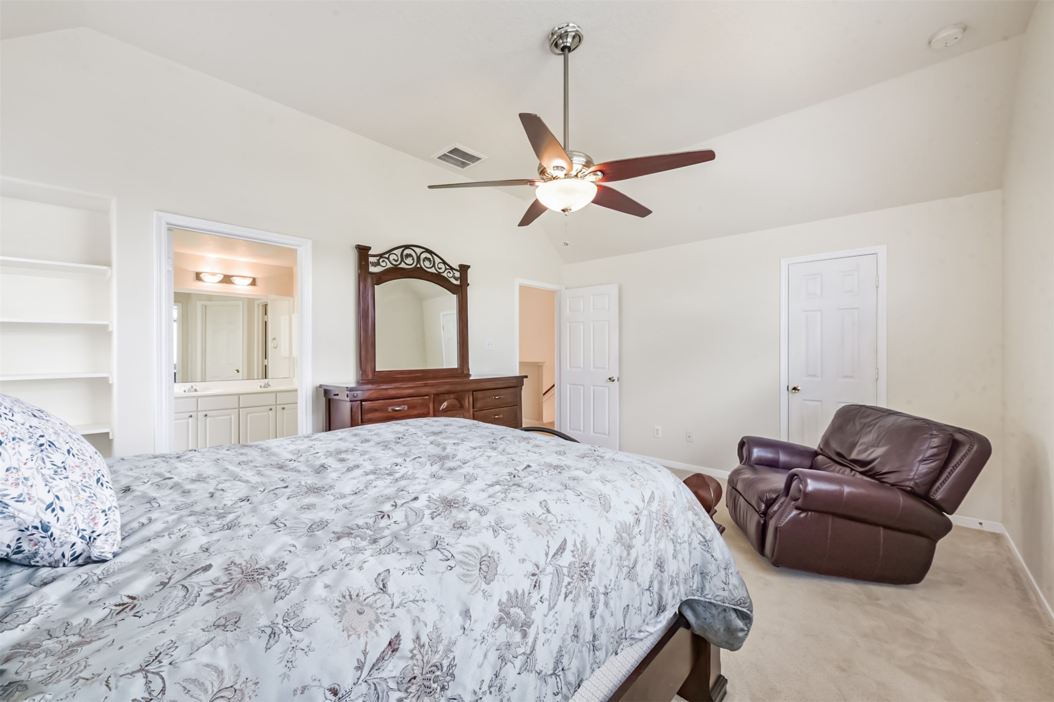 1810 Sun Point Court Humble, TX 77396 - Photo 25 of 38 a bedroom with a bed ceiling fan and a dresser