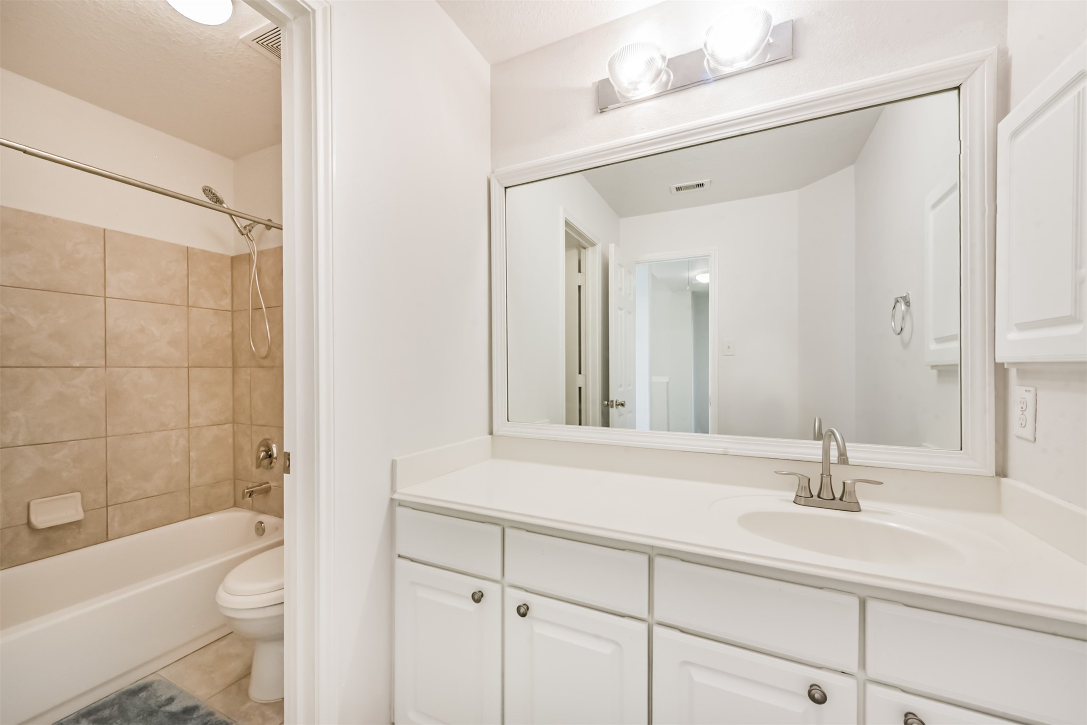 1810 Sun Point Court Humble, TX 77396 - Photo 34 of 38 a bathroom with a bathtub shower sink vanity and toilet