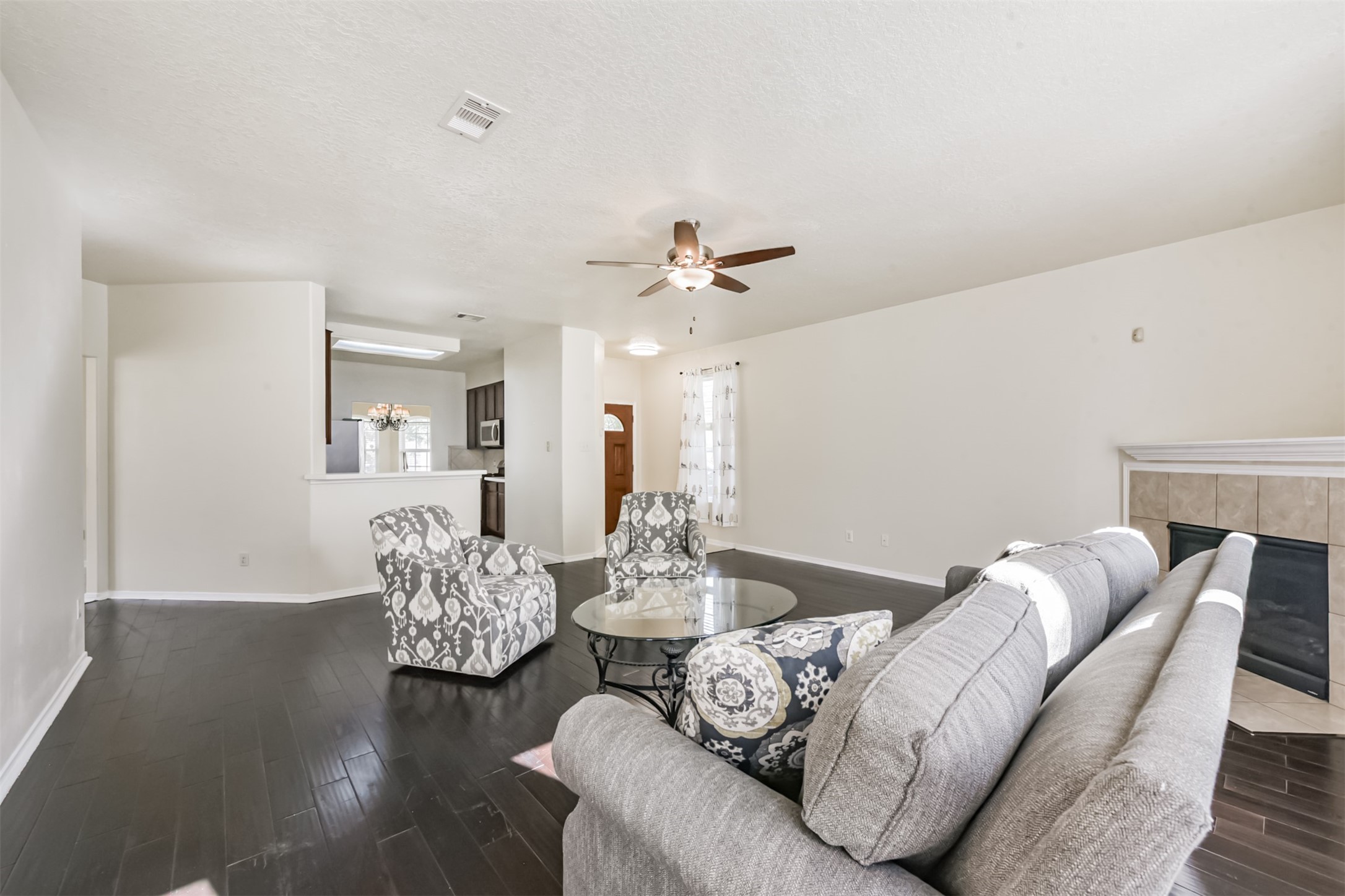 1810 Sun Point Court Humble, TX 77396 - Photo 8 of 38 a living room with furniture and a chandelier