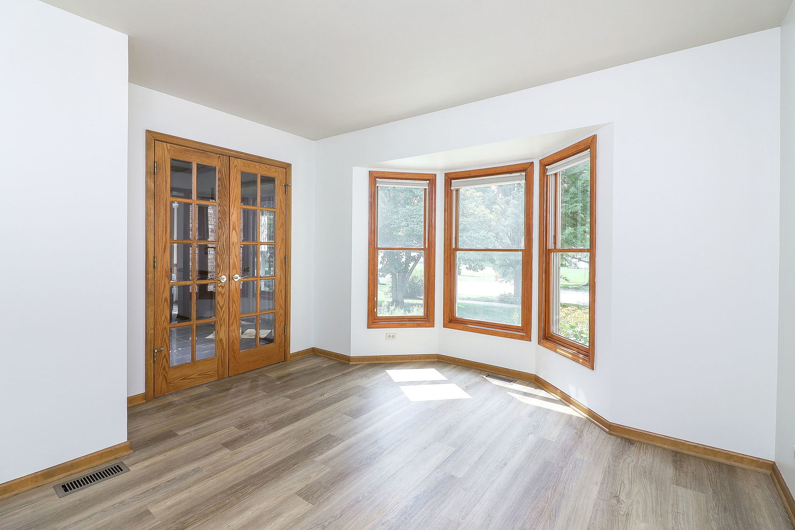 1736 Mundelein Road Naperville, IL 60565 - Photo 15 of 30 an empty room with wooden floor and windows