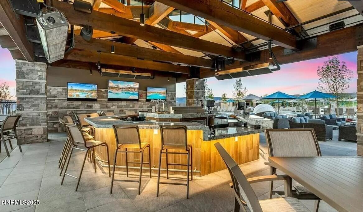 5728 Indigo Run Drive, Unit 1929 Reno, NV 89511 - Photo 7 of 10 a patio with swimming pool table and chairs