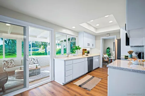 a kitchen with stainless steel appliances granite countertop a refrigerator and a stove top oven