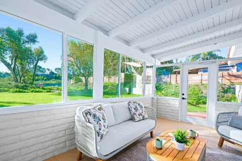 a living room with furniture and a potted plant