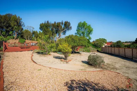 an aerial view of a house with a yard and garden