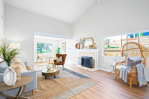 a living room with furniture a fireplace and a table