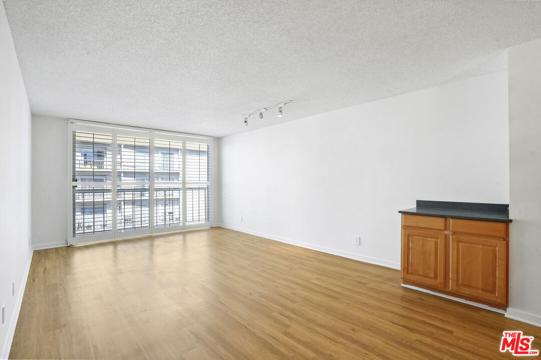 10751 Wilshire Boulevard, Unit PH 6 Los Angeles, CA 90024 - Photo 11 of 41 wooden floor in an empty room with a window