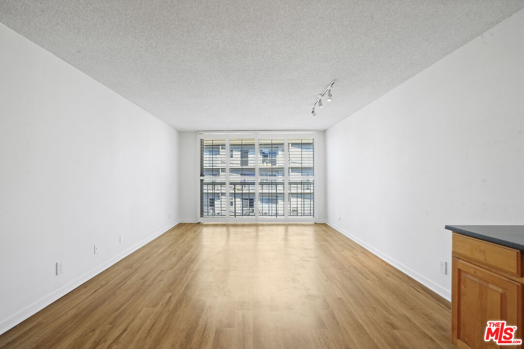 10751 Wilshire Boulevard, Unit PH 6 Los Angeles, CA 90024 - Photo 12 of 41 wooden floor in an empty room with a window