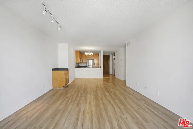 a view of a kitchen with wooden floor and a sink
