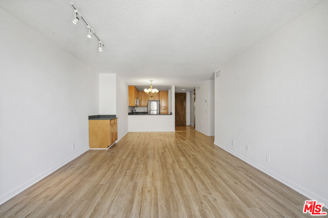 10751 Wilshire Boulevard, Unit PH 6 Los Angeles, CA 90024 - Photo 18 of 41 a view of a kitchen with wooden floor and front door