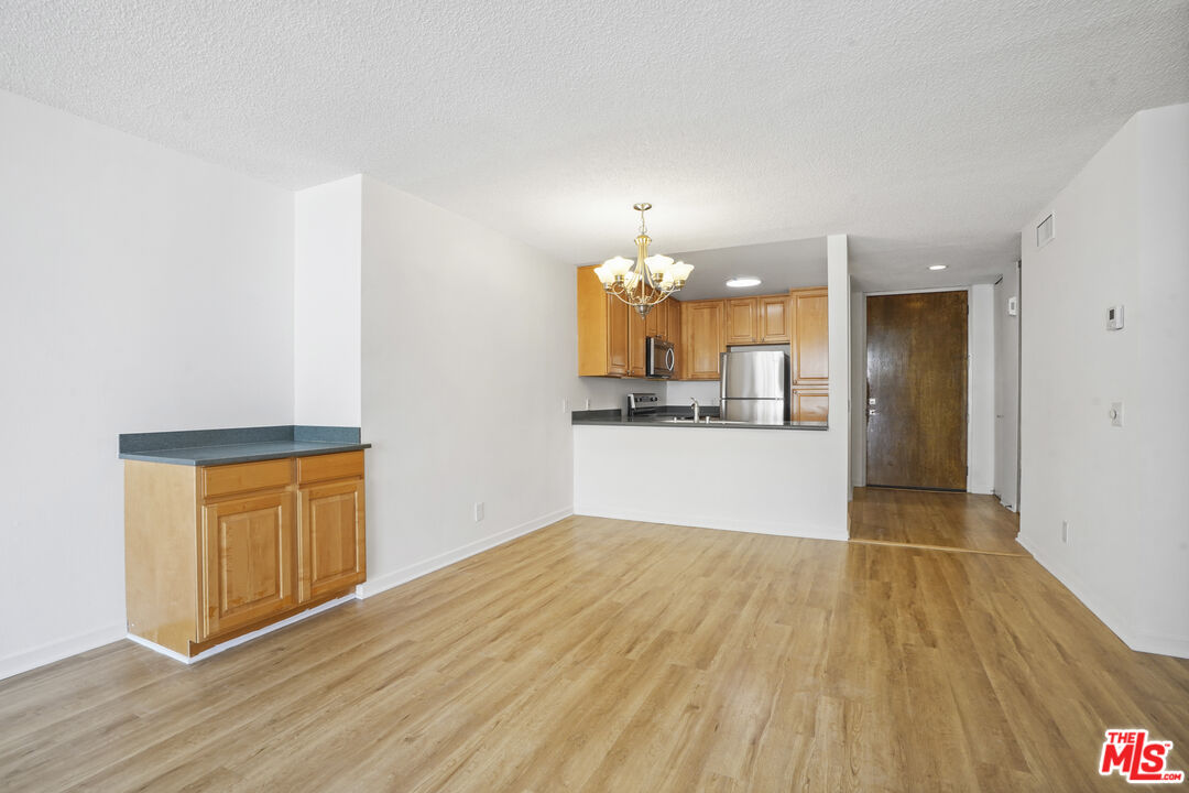 10751 Wilshire Boulevard, Unit PH 6 Los Angeles, CA 90024 - Photo 19 of 41 a view of a kitchen with wooden floor and a sink