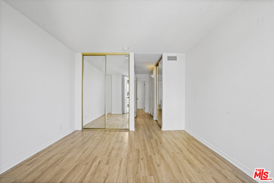 10751 Wilshire Boulevard, Unit PH 6 Los Angeles, CA 90024 - Photo 29 of 41 a view of an empty room with wooden floor