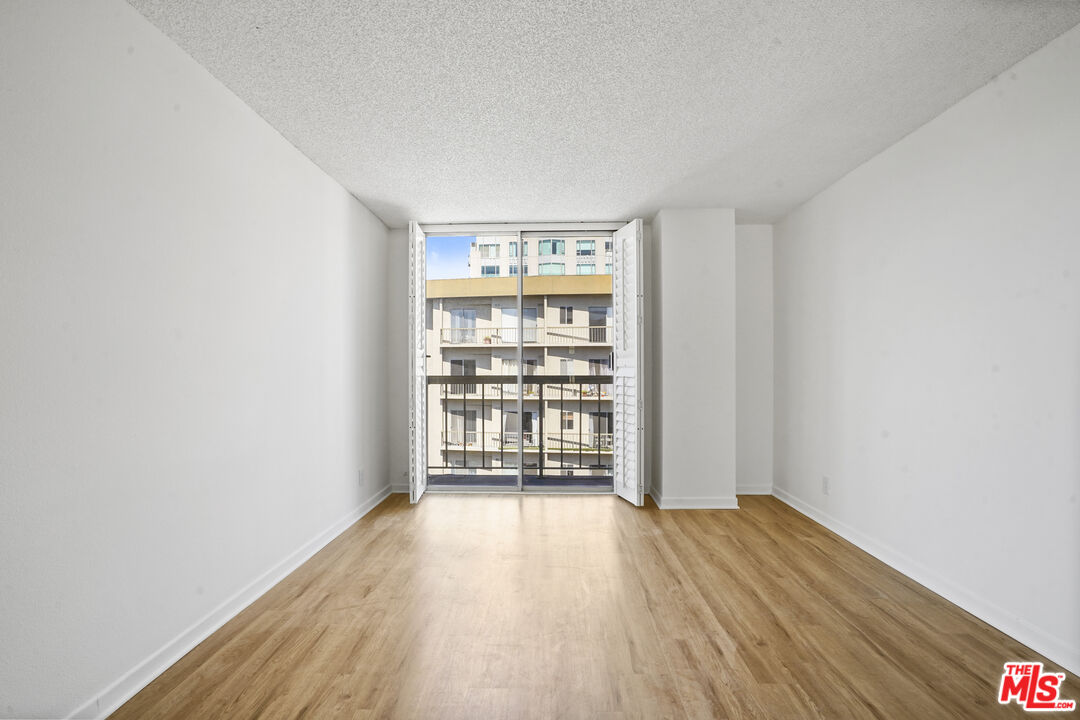 10751 Wilshire Boulevard, Unit PH 6 Los Angeles, CA 90024 - Photo 30 of 41 wooden floor in an empty room with a window