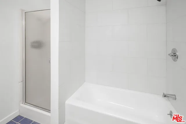 a view of a buildings and car parked on the roadside