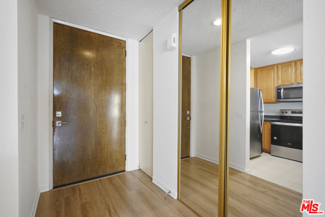 10751 Wilshire Boulevard, Unit PH 6 Los Angeles, CA 90024 - Photo 38 of 41 a view of kitchen with a refrigerator and a sink