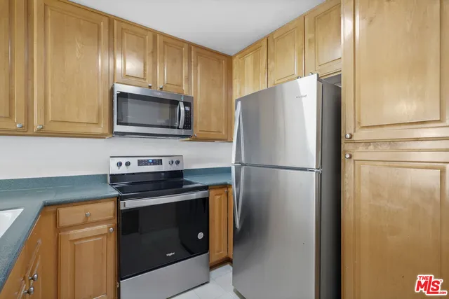 a kitchen with a refrigerator sink and microwave