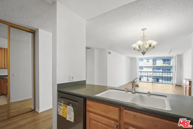 a kitchen with a sink and chandelier