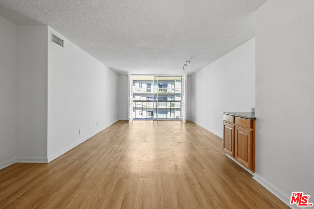 10751 Wilshire Boulevard, Unit PH 6 Los Angeles, CA 90024 - Photo 10 of 41 wooden floor in an empty room with a window