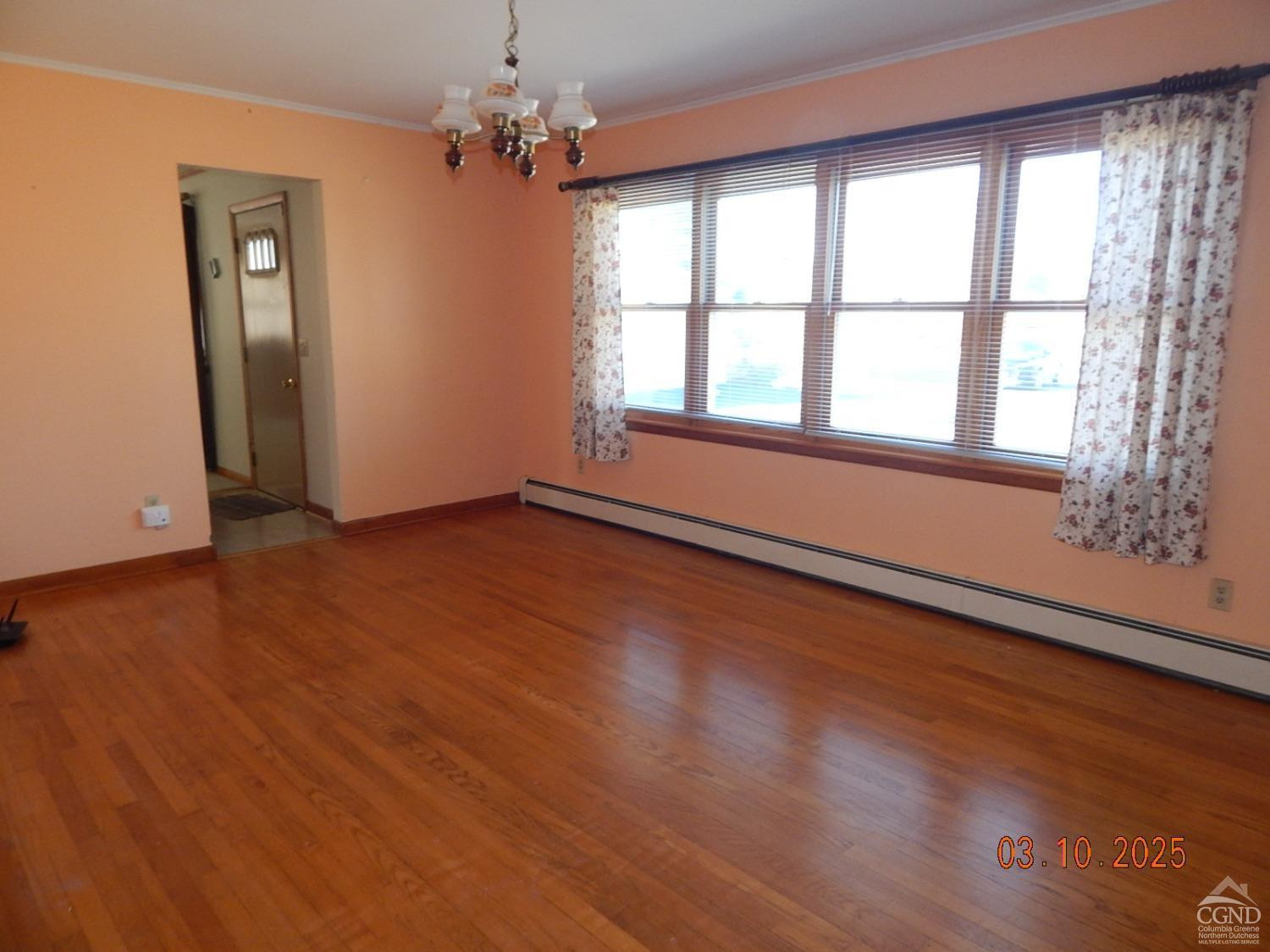 721 Irving Road Greenville, NY 12083 - Photo 15 of 29 a view of an empty room with wooden floor and a window