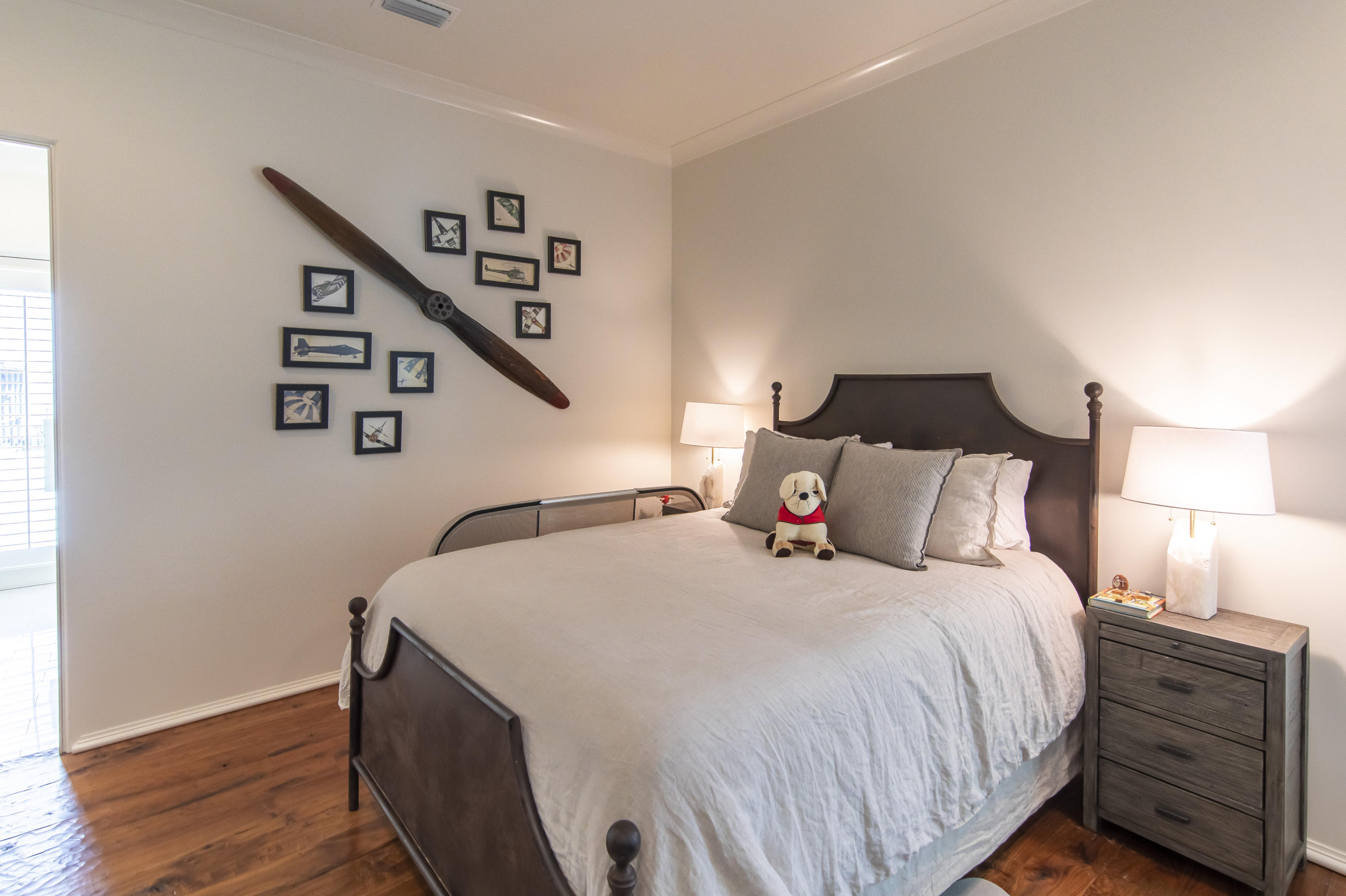 1095 Driftwood Point Road Santa Rosa Beach, FL 32459 - Photo 22 of 44 a bedroom with a bed and a chandelier