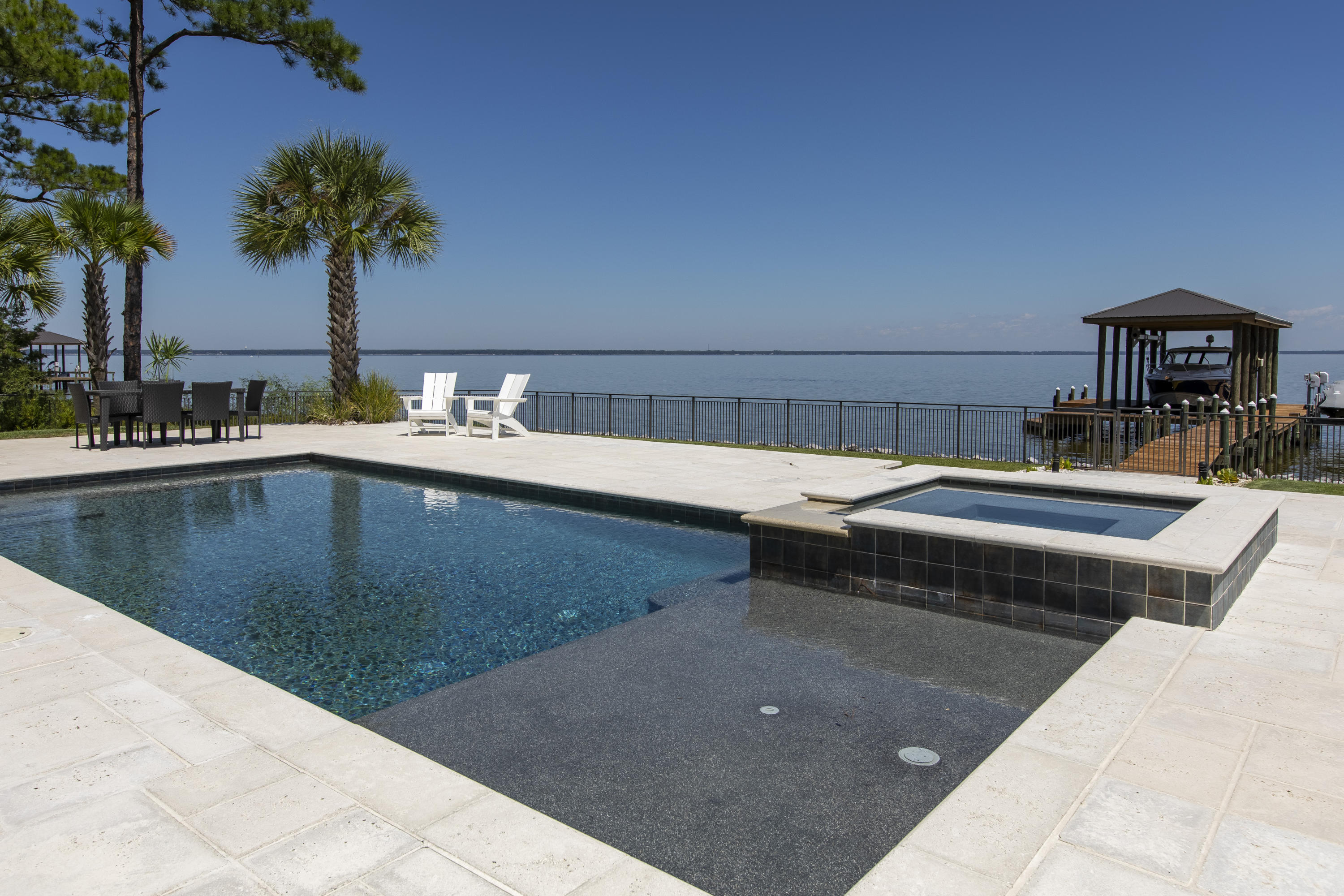 1095 Driftwood Point Road Santa Rosa Beach, FL 32459 - Photo 36 of 44 a terrace with a table and chairs potted plants