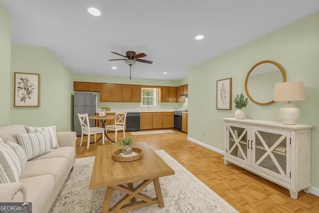 a living room with furniture a fireplace and a flat screen tv