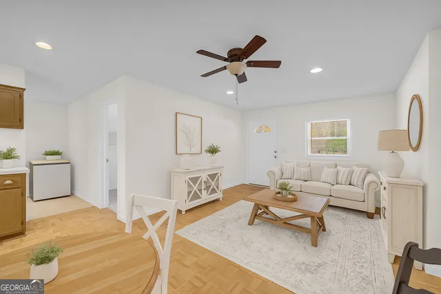 a living room with furniture and a wooden floor