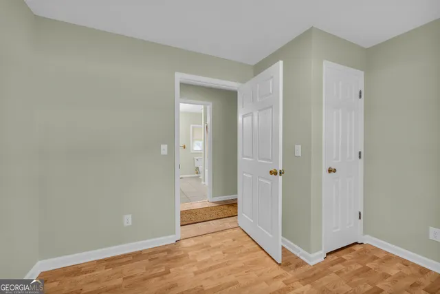 a bedroom with a bed ceiling fan and a window