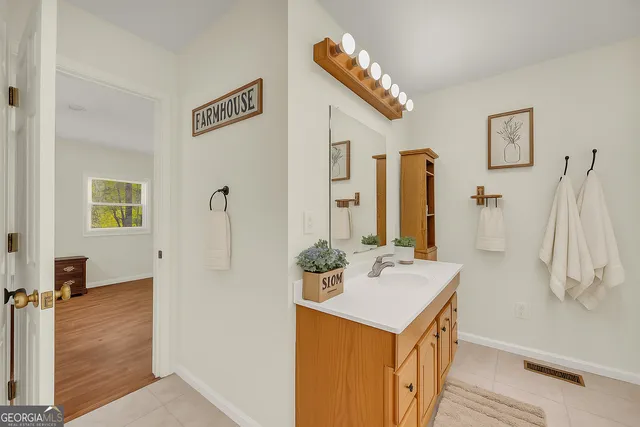 a bathroom with a sink a toilet and shower curtain