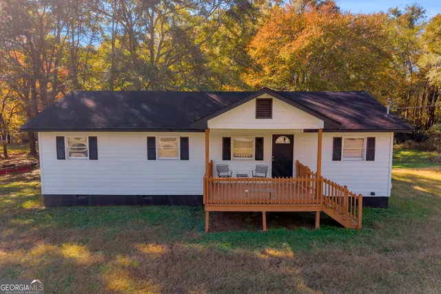 a front view of a house with a garden and deck