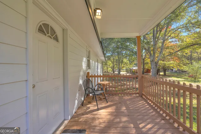 a view of a porch with furniture and garden
