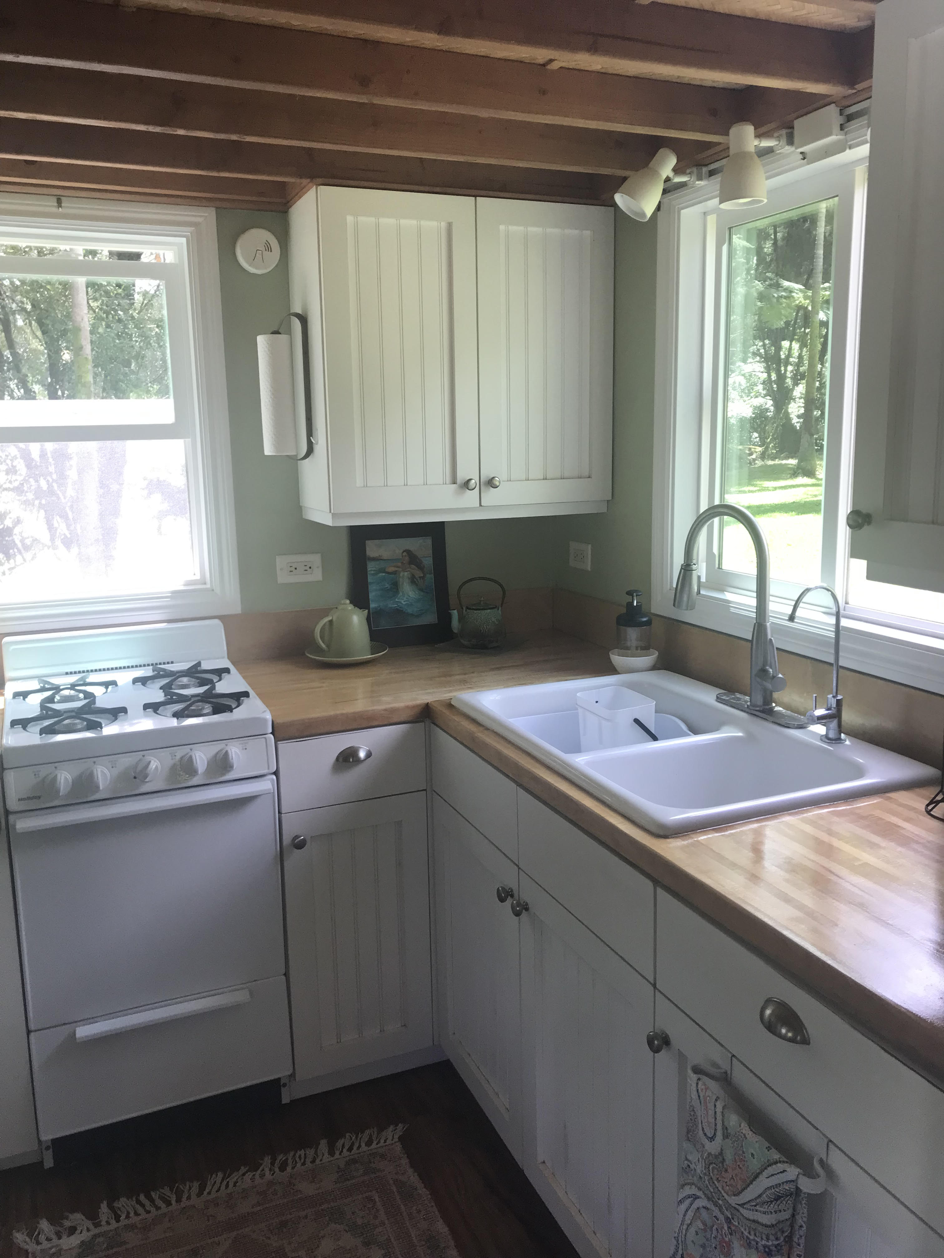 Lot A-2 Chin Chuck Road Papaikou, HI 96781 - Photo 8 of 30 a kitchen with a sink stove and cabinets